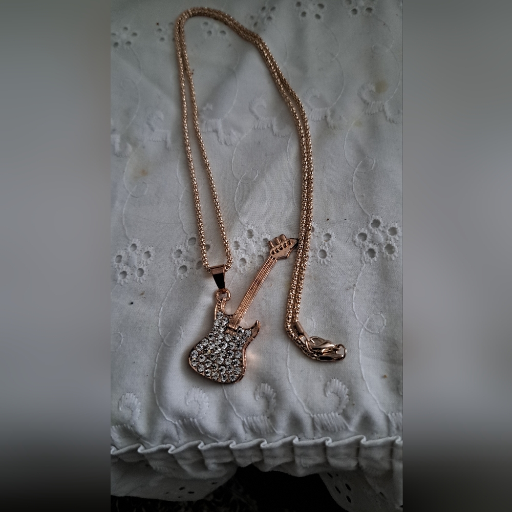 A  long guitar necklace.